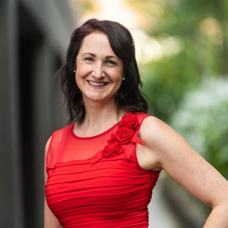 Assoc Prof Jane Tiller smiling in red top with long dark hair