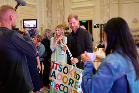 Prince Harry receives gifts during a SuperHumans fundraising lunch at the Fairmont Hotel in Kyiv.