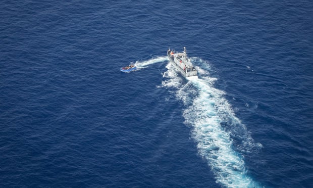 This aerial image taken on 30 June shows Libyan coastguards near a migrant boat in the Malta search and rescue zone. Footage showed the patrol boat apparently firing at the smaller boat