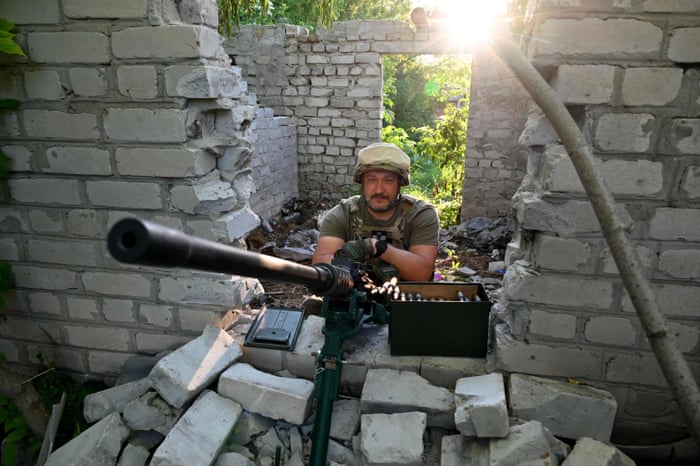 A Ukrainian serviceman keeps his position not far from the town of Chuguiv, in the Kharkiv region on 9 June.