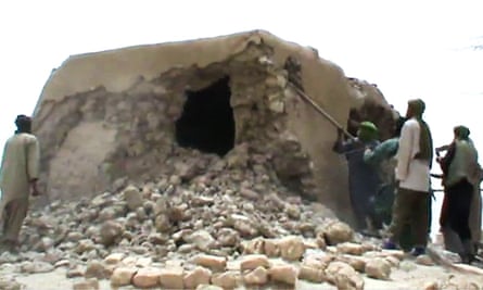 Islamist militants destroying an ancient shrine in Timbuktu.