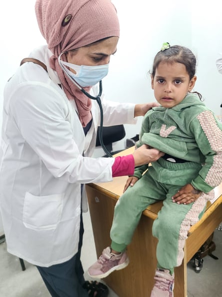 A doctor cares for a child