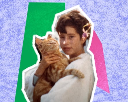 Teenage girl with short back and sides haircut holding a ginger cat