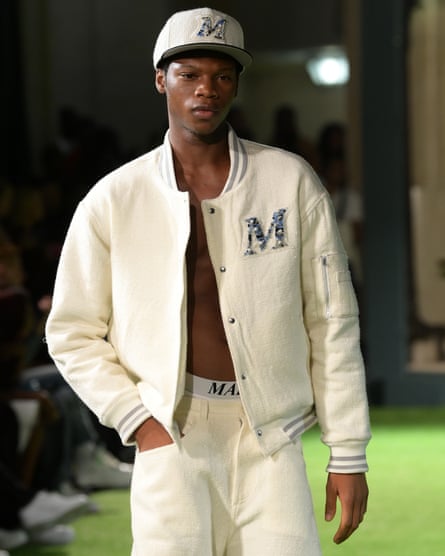 A model wears a bomber jacket in ivory bouclé