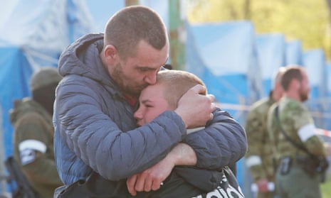 Azovstal steel plant employee Maxim, last name withheld, hugs his son Matvey, who had left the city earlier with some relatives.