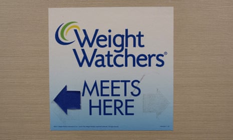 Sign for Weight Watchers on a wall.
