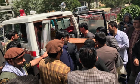 Relatives and friends lift a coffin containing the body of the Agence France-Presse photographer Shah Marai, who was killed in the twin bomb blasts in Kabul
