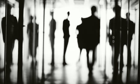 Office workers silhouetted in corridor.