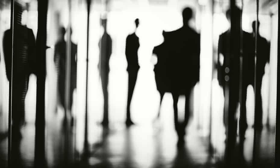 Silhouettes of office workers in the corridor of a business centre