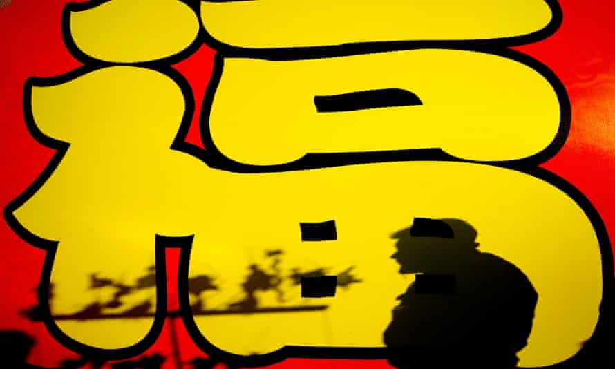 Prince Andrew Loses Military Roles And Use Of HRH Title | First Thing 5 A vendor in front of the Chinese character fu (good fortune) at lunar new year.