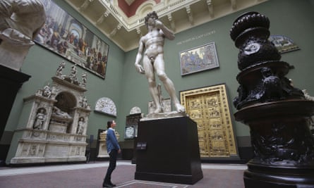 A visitor looks at a cast of David by Michelangelo in the Weston Cast Court in the V&A.