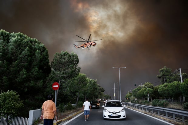 A firefighting helicopter tackles a blaze in a suburb of Athens last year.