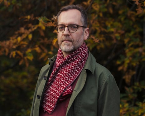 Writer David Batty in green coat and burgundy top and scarf