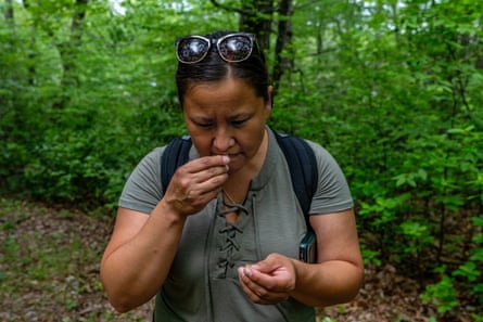 A woman smells a chesnut husk