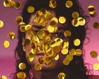 Portrait of a Michael Jackson partly obscured by falling gold confetti