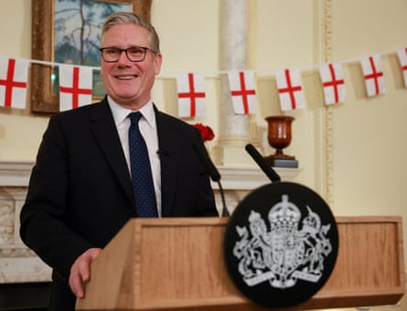 Keir Starmer stood at a lecturn with English flags behind him