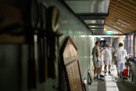 People talking beside real tennis court
