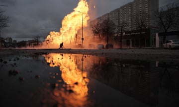 A firefighter attempts to extinguish a fire after a missile strike in Kyiv.