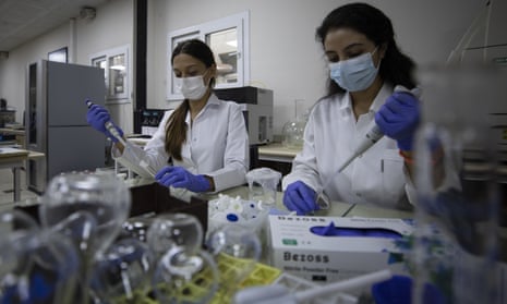 Lab technicians conduct tests for a Covid vaccine at Ege University in Izmir, Turkey.
