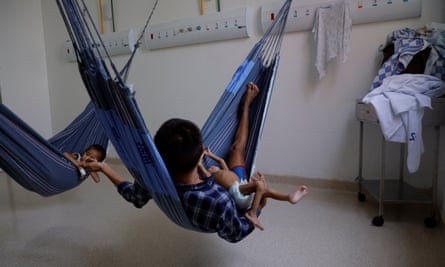 Yanomami Indigenous children being treated for malnutrition on hammocks with their father at the special ward for Indigenous people ar the Santo Antônio children’s hospital in Boa Vista, Roraima state, Brazil on 27 January 2023.