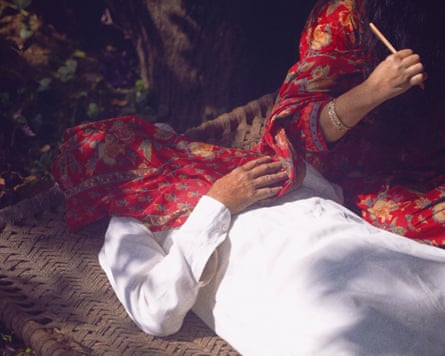A couple lying down, with a scarf covering them.