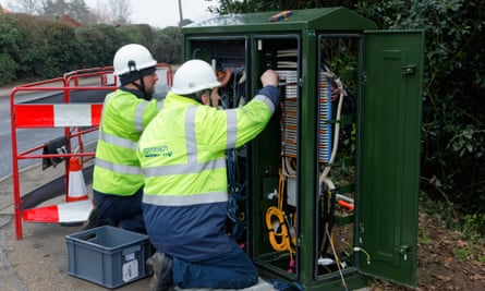 BT Openreach engineers working on a broadband internet fibre cabinet in the street