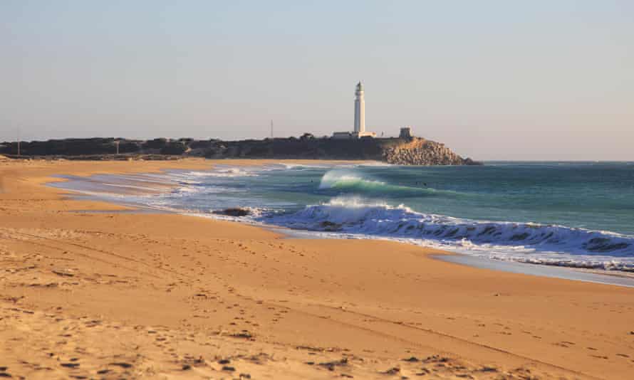 Sandy beach and lighthouse at Cabo de Trafalga