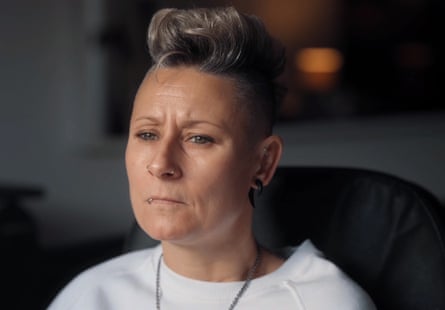 A woman wearing a white T-shirt, with nose rings and a lip ring
