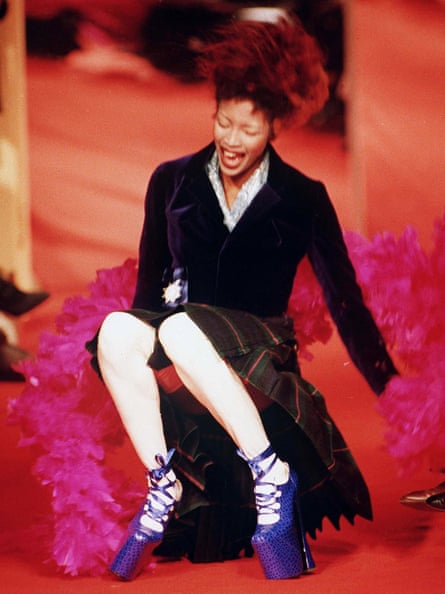 Naomi Campbell laughs after falling during a Vivienne Westwood show in Paris in 1993.