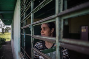 Parents’ representative Silvia Márquez looks through one of the school’s glassless windows. ‘We’re sick to the back teeth,’ she said.