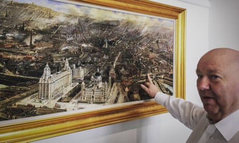Joe Anderson, the Mayor of Liverpool, pointing at an old painting entitled Modern Liverpool, 1907, that hangs inside his waterfront office