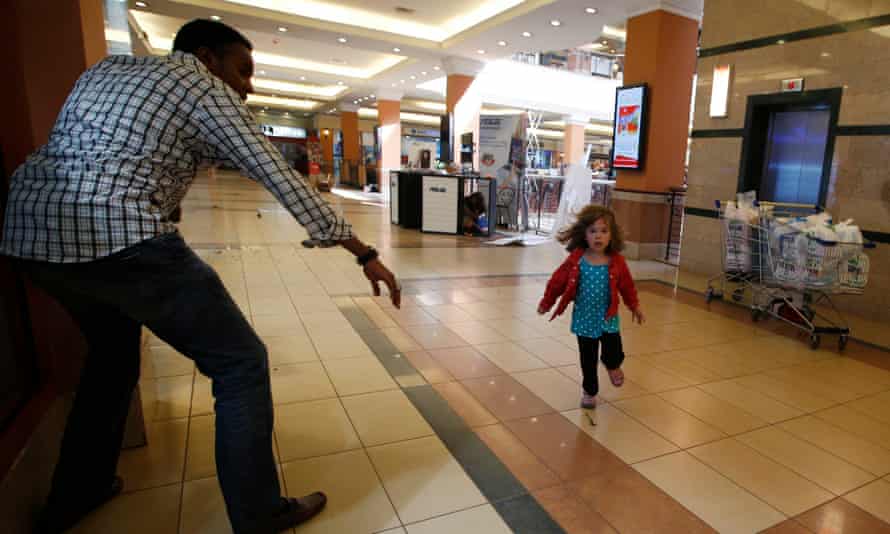 A child runs to safety in a shopping centre