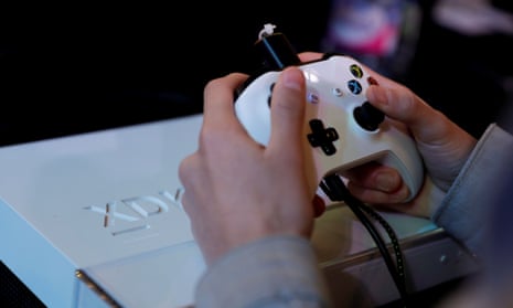 A gamer plays video games with a console