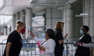 Medical personnel take temperature as they prepare the Ernest N Morial convention center for Covid-19 patients in New Orleans, Louisiana, on Monday.