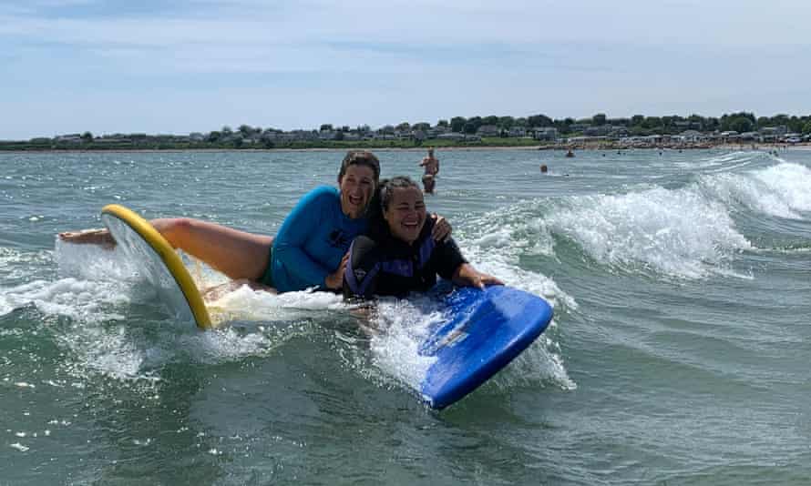 Prof Laurie Santos, right, with a friend, found that surfing allowed her to experience vulnerability.