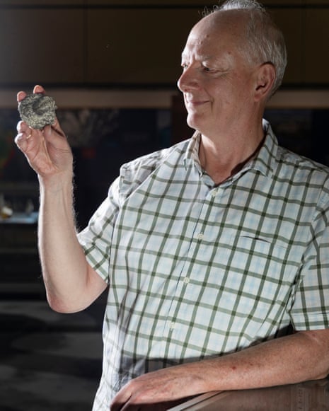 Craig Munns with a trilobite fossil.