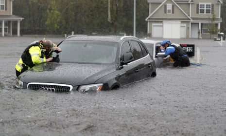 Members of the North Carolina Task Force urban search and rescue team check cars in a flooded neighborhood looking for residents who stayed behind as Florence continues to dump heavy rain in Fayetteville, North Carolina