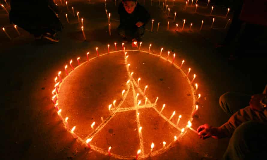 Nepalese people form the shape of the Eiffel Tower with candles during a candlelight vigil, in Kathmandu, Nepal.