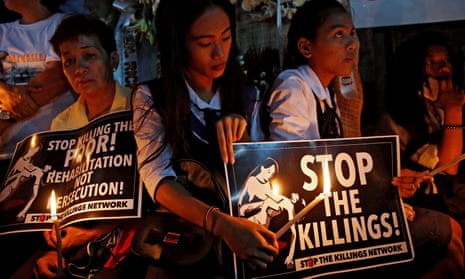 Protesters and residents hold candles and placards after the killing of Kian Loyd delos Santos, a 17-year-old student and victim of Rodrigo Duterte’s war on drugs in the Philippines.