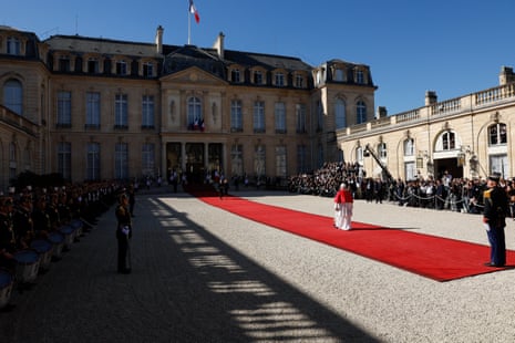 Pope Leo XIV walks on a red carpet toward France's President Emmanuel Macron and his wife Brigitte Macron ahead of a meeting at the Elysee Presidential Palace, in Paris on September 25, 2026 at the start of his four days visit to France.
