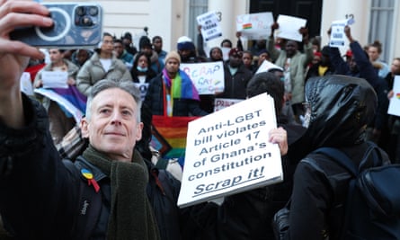 Peter Tatchell at a protest march taking a selfie