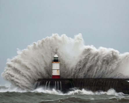 Waves crash over the lighthouse at Newhaven Harbour during Storm Austen on Friday.