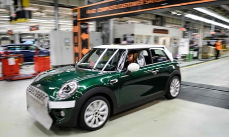 A Mini is driven off the assembly line at Cowley.