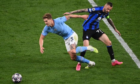 John Stones of Manchester City skips past a challenge from Marcelo Brozovic of Inter.