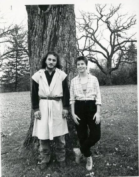 Black and white image of man and woman in front of tree.