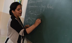 Teacher writing on board in India