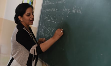 Teacher writing on board in India