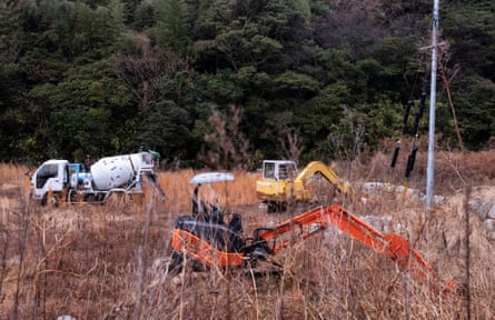 Digging equipment and cement trucks on a plot of land