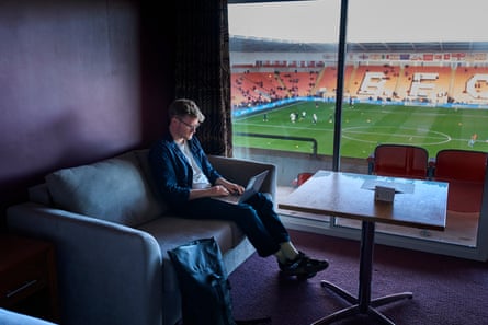 Michael Butler types on his laptop from the Blackpool FC stadium hotel before the game.