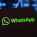 Green WhatsApp logo on a black screen